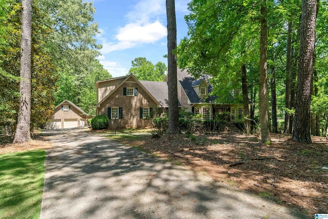 4737 Cloud Ln, Birmingham, AL 35243 - view of front of house with an outbuilding, a garage, and brick siding