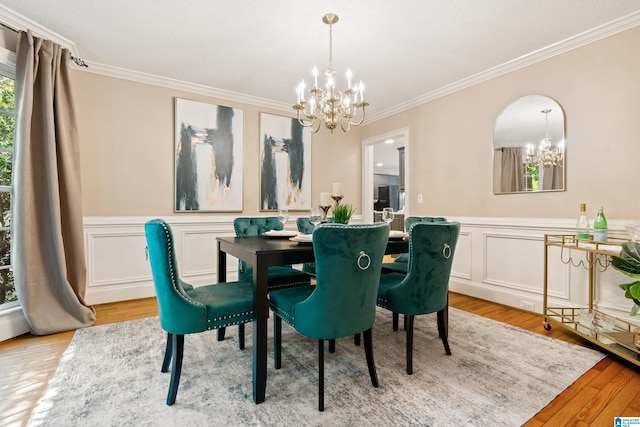 4737 Cloud Ln, Birmingham, AL 35243 - dining space featuring a chandelier, crown molding, light wood-style flooring, a wainscoted wall, and a decorative wall