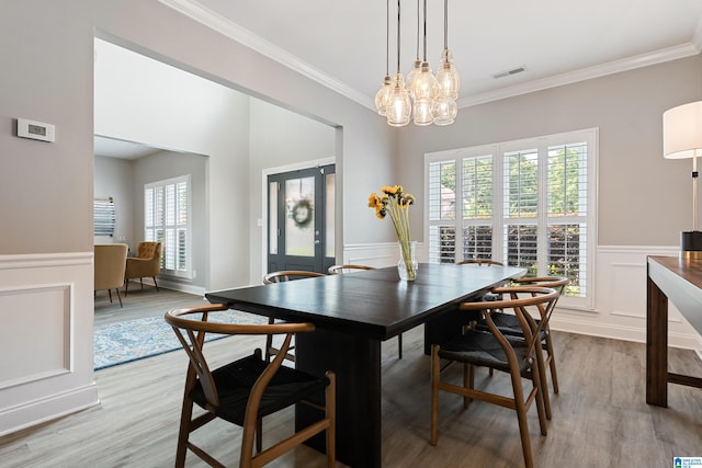 483 Old Cahaba Way, Helena, AL 35080 - dining space featuring plenty of natural light, ornamental molding, light wood-style flooring, a chandelier, and a wainscoted wall