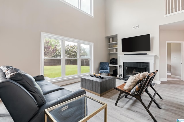 483 Old Cahaba Way, Helena, AL 35080 - living area featuring a high ceiling, a fireplace, healthy amount of natural light, and light wood-style flooring