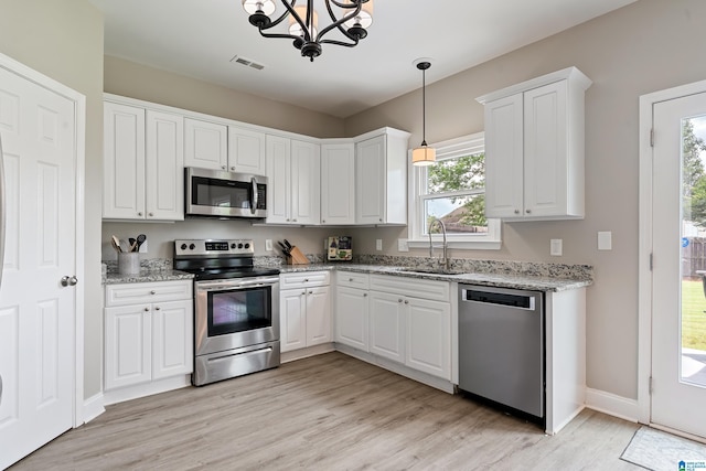 483 Old Cahaba Way, Helena, AL 35080 - kitchen with appliances with stainless steel finishes, light wood-style floors, a chandelier, and white cabinets