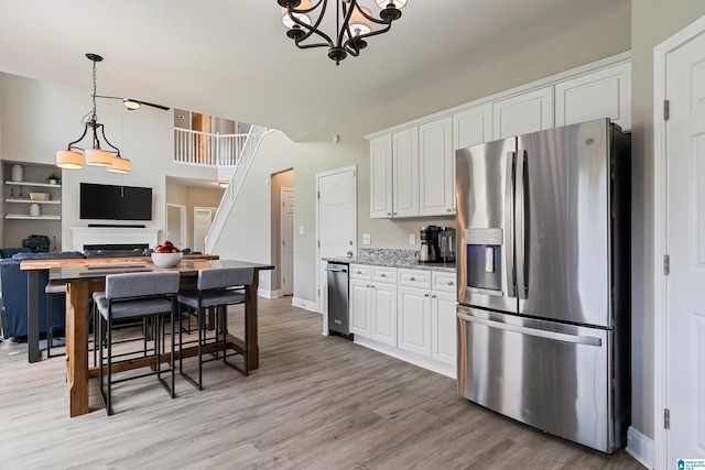 483 Old Cahaba Way, Helena, AL 35080 - kitchen featuring stainless steel appliances, light wood-style flooring, white cabinets, and open floor plan