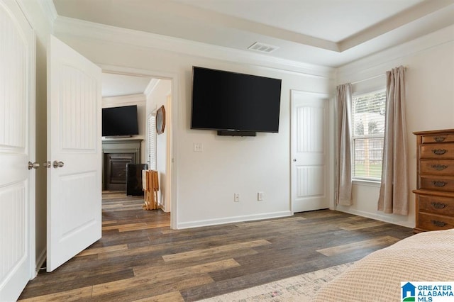 8613 Clarke Ln, Leeds, AL 35094 - bedroom featuring dark wood-type flooring, crown molding, and a fireplace