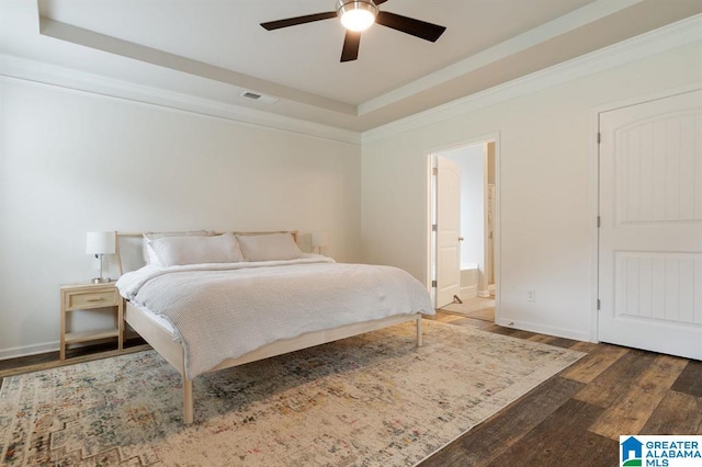 8613 Clarke Ln, Leeds, AL 35094 - bedroom featuring wood finished floors, a tray ceiling, ornamental molding, ensuite bath, and ceiling fan