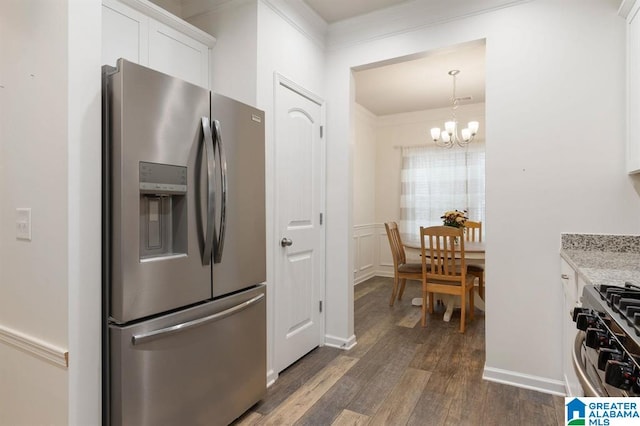 8613 Clarke Ln, Leeds, AL 35094 - kitchen with stainless steel fridge with ice dispenser, stove, dark wood-style floors, a chandelier, and white cabinets