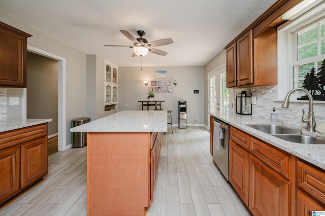 3350 Rosemary Ln, Vestavia Hills, AL 35216 - kitchen featuring a center island, decorative backsplash, a ceiling fan, dishwasher, and light wood-style floors
