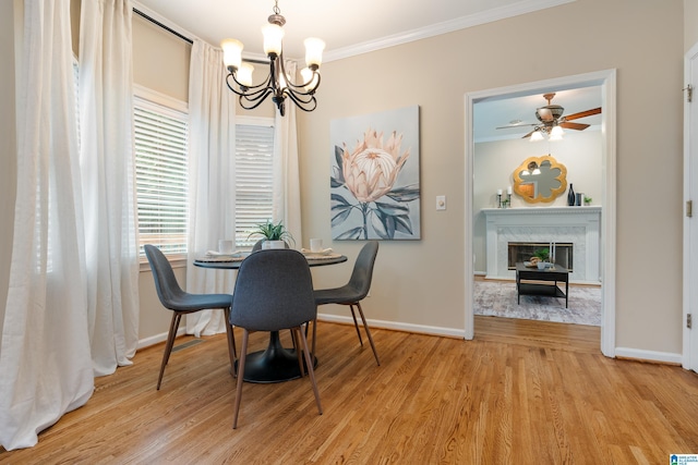 1812 Cross Cir, Hoover, AL 35244 - dining space featuring a chandelier, ornamental molding, light wood finished floors, a high end fireplace, and a ceiling fan