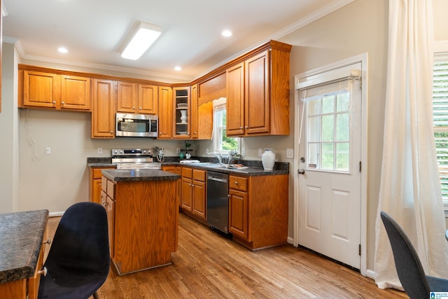 1812 Cross Cir, Hoover, AL 35244 - kitchen with appliances with stainless steel finishes, a center island, brown cabinetry, ornamental molding, and dark countertops