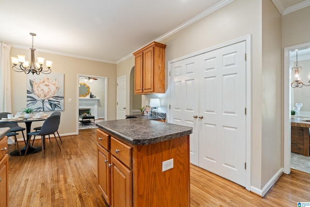 1812 Cross Cir, Hoover, AL 35244 - kitchen with a chandelier, brown cabinets, light wood-type flooring, and crown molding