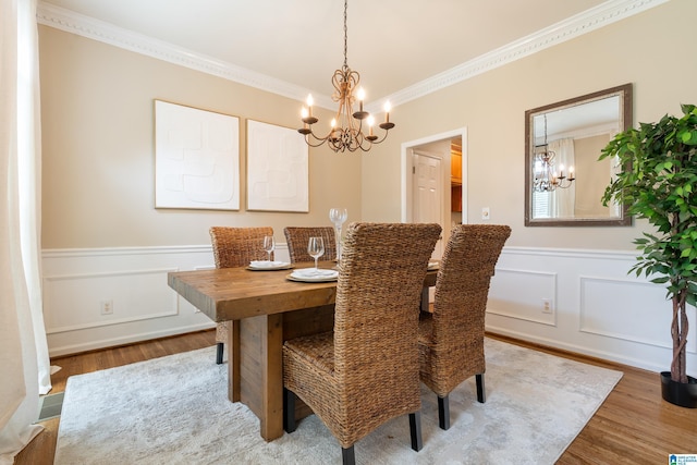 1812 Cross Cir, Hoover, AL 35244 - dining area featuring a chandelier, crown molding, wood finished floors, wainscoting, and a decorative wall
