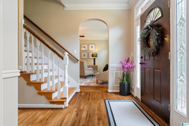 1812 Cross Cir, Hoover, AL 35244 - foyer entrance with light wood-style floors, arched walkways, crown molding, and stairs