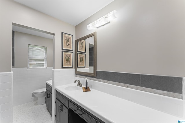 8892 Moody Pkwy, Odenville, AL 35120 - full bath featuring double vanity, a wainscoted wall, tile walls, and tile patterned floors