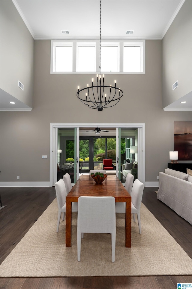 3041 Adley Cir, Hoover, AL 35244 - dining space with a towering ceiling, ornamental molding, a chandelier, wood finished floors, and ceiling fan