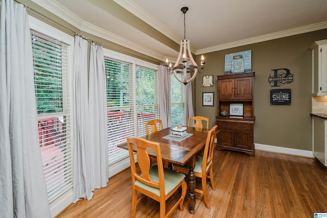 4208 Waterford Ln, Trussville, AL 35173 - dining space with a chandelier, ornamental molding, and light wood-type flooring