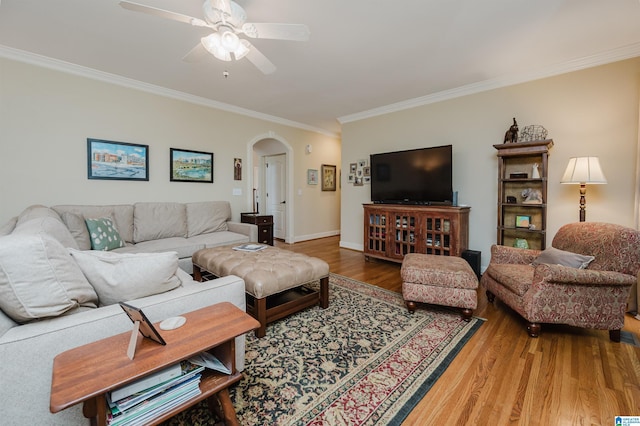 4208 Waterford Ln, Trussville, AL 35173 - living room with arched walkways, crown molding, wood finished floors, and a ceiling fan