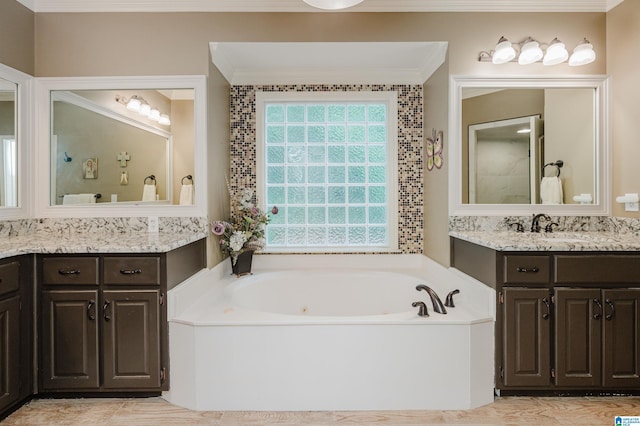 4208 Waterford Ln, Trussville, AL 35173 - bathroom with crown molding, a garden tub, and two vanities