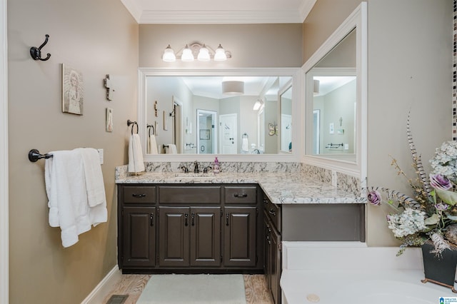 4208 Waterford Ln, Trussville, AL 35173 - bathroom with vanity, ornamental molding, and a garden tub