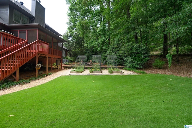 4208 Waterford Ln, Trussville, AL 35173 - view of green lawn with stairway, a vegetable garden, a deck, and a sunroom