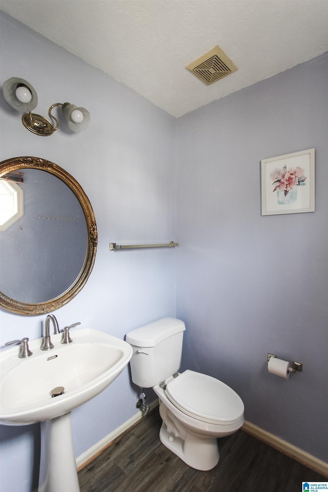 1534 Cambridge Pl, Anniston, AL 36207 - bathroom featuring toilet and wood finished floors