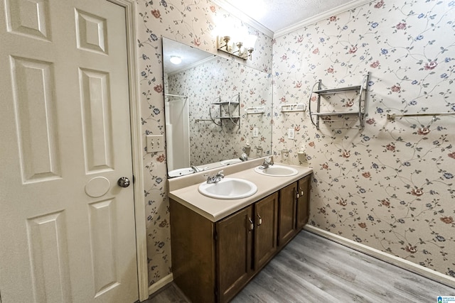1534 Cambridge Pl, Anniston, AL 36207 - full bath with wallpapered walls, ornamental molding, wood finished floors, double vanity, and a shower