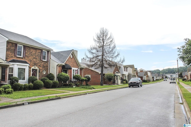 1534 Cambridge Pl, Anniston, AL 36207 - view of asphalt road with a residential view, curbs, and sidewalks