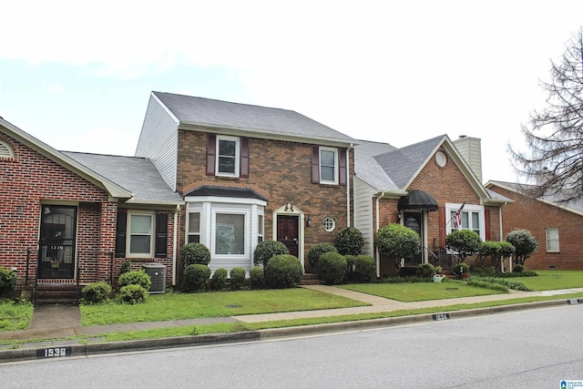 1534 Cambridge Pl, Anniston, AL 36207 - traditional-style home featuring brick siding and a front lawn