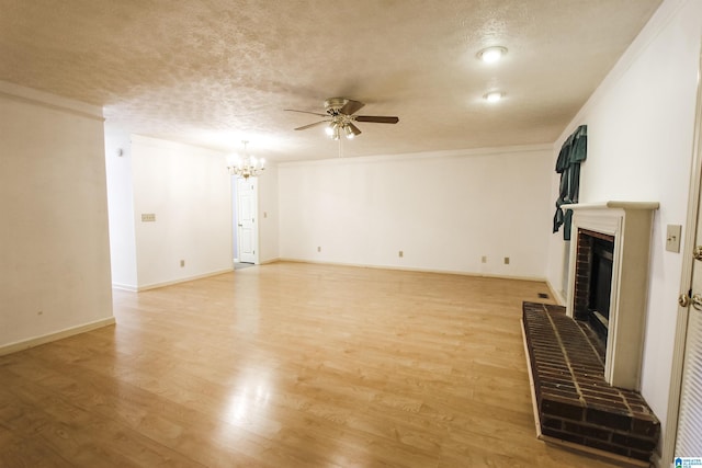 1534 Cambridge Pl, Anniston, AL 36207 - unfurnished living room with ceiling fan, a chandelier, a brick fireplace, light wood-type flooring, and a textured ceiling