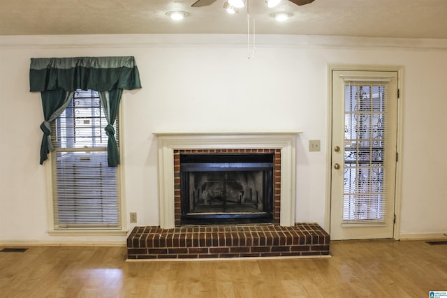 1534 Cambridge Pl, Anniston, AL 36207 - detailed view of wood finished floors, ceiling fan, and a brick fireplace