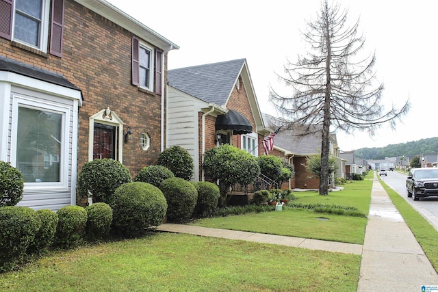 1534 Cambridge Pl, Anniston, AL 36207 - view of home's exterior featuring brick siding, a lawn, and a residential view