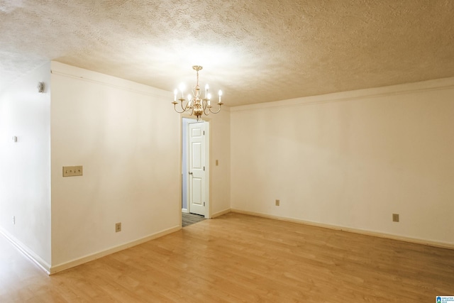 1534 Cambridge Pl, Anniston, AL 36207 - empty room featuring a textured ceiling, light wood-style flooring, and a chandelier