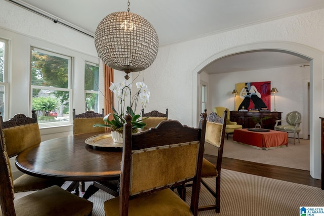 117 Elm St, Mountain Brook, AL 35213 - dining space with arched walkways, a textured wall, and wood finished floors