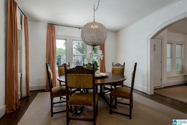 117 Elm St, Mountain Brook, AL 35213 - dining room featuring a textured wall, arched walkways, dark wood finished floors, and ornamental molding
