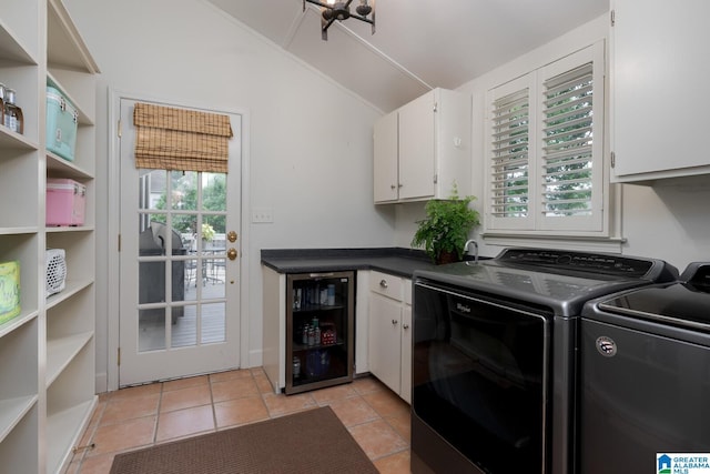 117 Elm St, Mountain Brook, AL 35213 - laundry area featuring cabinet space, independent washer and dryer, and light tile patterned flooring