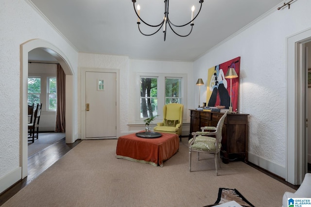 117 Elm St, Mountain Brook, AL 35213 - living area featuring ornamental molding, arched walkways, a chandelier, wood finished floors, and a textured wall