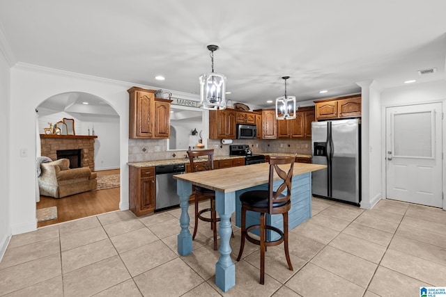 2043 Maplewood Ln, Clanton, AL 35045 - kitchen with appliances with stainless steel finishes, a chandelier, recessed lighting, light tile patterned floors, and backsplash