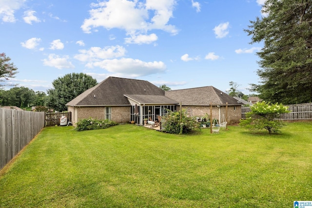 2043 Maplewood Ln, Clanton, AL 35045 - rear view of property with a sunroom, a fenced backyard, and brick siding
