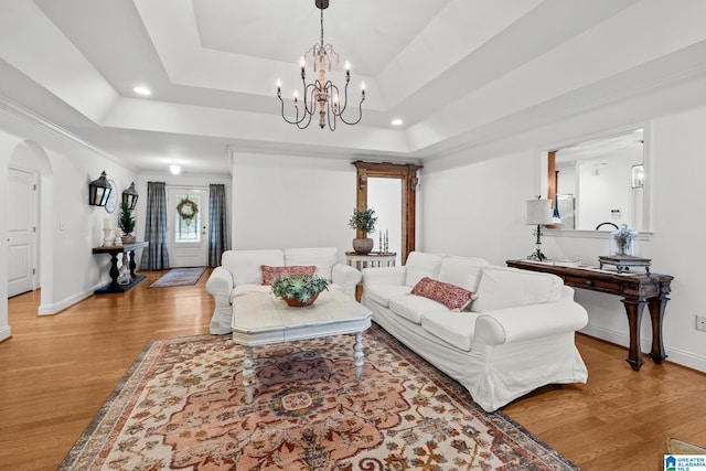 2043 Maplewood Ln, Clanton, AL 35045 - living area with a tray ceiling, light wood finished floors, a chandelier, arched walkways, and recessed lighting