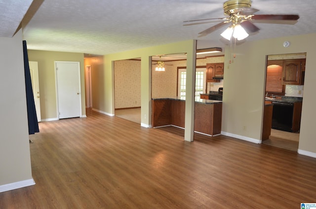 6301 Cedar Ct, Anniston, AL 36206 - unfurnished living room with a ceiling fan, dark wood-type flooring, and a textured ceiling
