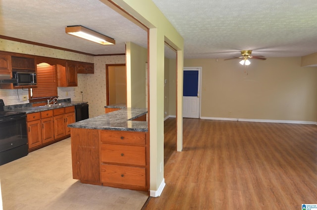 6301 Cedar Ct, Anniston, AL 36206 - kitchen featuring black appliances, ceiling fan, a textured ceiling, light wood finished floors, and brown cabinetry