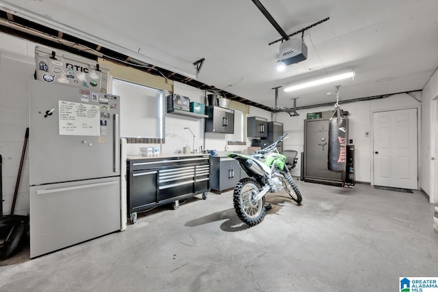 1025 Old Section Rd, Hoover, AL 35244 - garage featuring freestanding refrigerator, a garage door opener, and electric panel