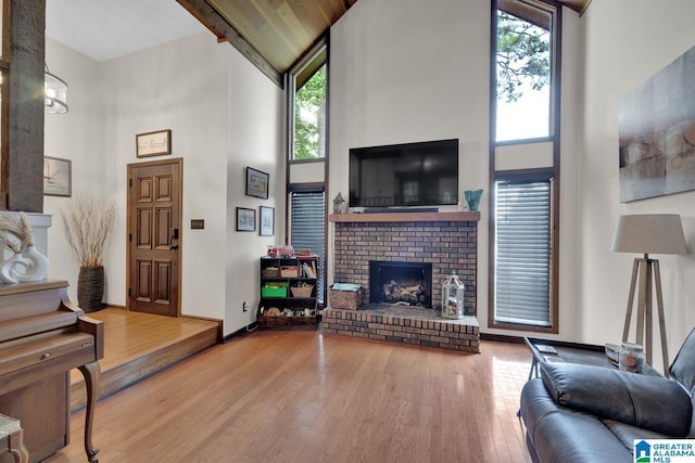 1025 Old Section Rd, Hoover, AL 35244 - living area featuring a towering ceiling, plenty of natural light, wood finished floors, and a brick fireplace