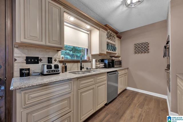 1025 Old Section Rd, Hoover, AL 35244 - kitchen with stainless steel dishwasher, cream cabinets, backsplash, dark wood-type flooring, and a textured ceiling