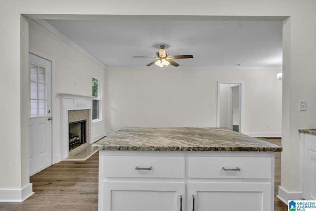 7945 Forest Loop, Pinson, AL 35126 - kitchen featuring ceiling fan, wood finished floors, ornamental molding, white cabinets, and stone countertops