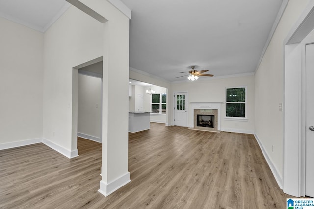 7945 Forest Loop, Pinson, AL 35126 - unfurnished living room with ornamental molding, ceiling fan, light wood-style flooring, a chandelier, and a fireplace