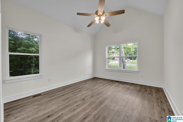 7945 Forest Loop, Pinson, AL 35126 - empty room with healthy amount of natural light, vaulted ceiling, wood finished floors, and ceiling fan