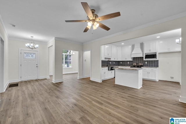 7945 Forest Loop, Pinson, AL 35126 - kitchen featuring stainless steel appliances, a chandelier, premium range hood, open floor plan, and white cabinets
