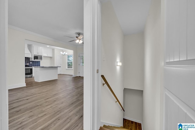 7945 Forest Loop, Pinson, AL 35126 - stairs featuring wood finished floors, a chandelier, a ceiling fan, and crown molding