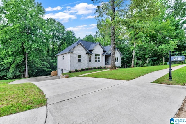 7945 Forest Loop, Pinson, AL 35126 - view of front of house featuring concrete driveway, a garage, a front lawn, and brick siding