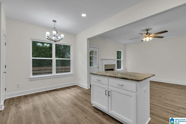 7945 Forest Loop, Pinson, AL 35126 - kitchen with wood finished floors, a chandelier, open floor plan, white cabinets, and a fireplace