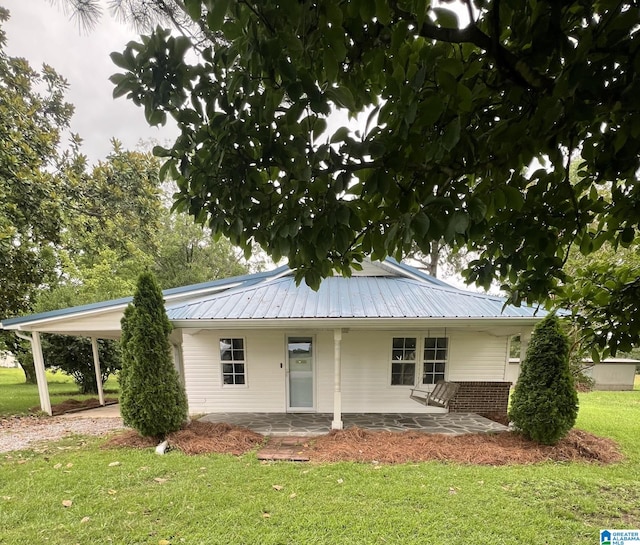 11539 County Road 51, Jemison, AL 35085 - view of front facade featuring a front yard, a metal roof, a carport, driveway, and brick siding
